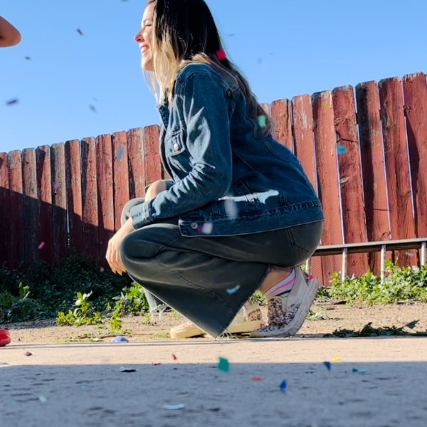 Rose Kelley laughing amid falling confetti
